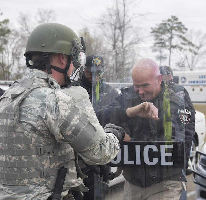 A Georgia Air National Guard security forces airman partners with Cpl. Greg Thomas, a police officer with the Macon-Bibb County Sheriff’s Department, to practice crowd control techniques during exercise Vigilant Guard 2017 in Macon, Ga., March 14, 2017. The 116th Air Control Wing and the 165th Airlift Wing worked with the Macon-Bibb Emergency Management Agency and other agencies to practice crowd control techniques as part of a hurricane simulation to ensure the safety of citizens during possible natural disasters or catastrophes. Vigilant Guard Georgia 2017 is a joint regional training exercise sponsored by U.S. Northern Command in conjunction with the National Guard Bureau. Georgia Air National Guard photo by Master Sgt. Regina Young