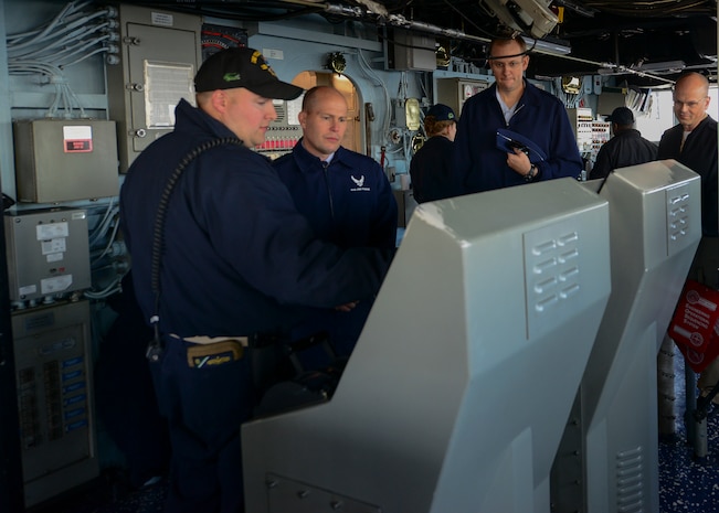 U.S. Navy amphibious dock landing ship USS Whidbey Island (LSD 41) visited Charleston, South Carolina over St. Patrick’s day weekend. Navy Lt. David Pagan, left, describes the ship’s helm while giving a tour to Air Force Col. Richard Mathews, commander, 628th Mission Support Group, center left; Air Force Lt. Col. Matthew Brennan, commander, 628th Civil Engineer Squadron, center right and Navy Cmdr. William Edenbeck Naval Support Activity Charleston’s Executive Officer, right. The Whidbey Island moored at Union Pier Terminal in downtown Charleston. 