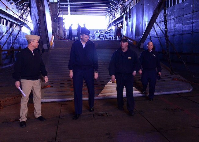 U.S. Navy amphibious dock landing ship USS Whidbey Island (LSD 41) visited Charleston, South Carolina, over St. Patrick’s day weekend. Lieutenant David Pagan describes the well deck operations and capabilities while giving a tour of ship USS Whidbey Island to U.S. Air Force Col. Richard Mathews, commander, 628th Mission Support Group, right; Lt. Col. Matthew Brennan, commander, 628th Civil Engineer Squadron, center left, and Navy Cmdr. William Edenbeck Naval Support Activity Charleston’s Executive Officer, left.  The Whidbey Island moored at Union Pier Terminal in downtown Charleston. 