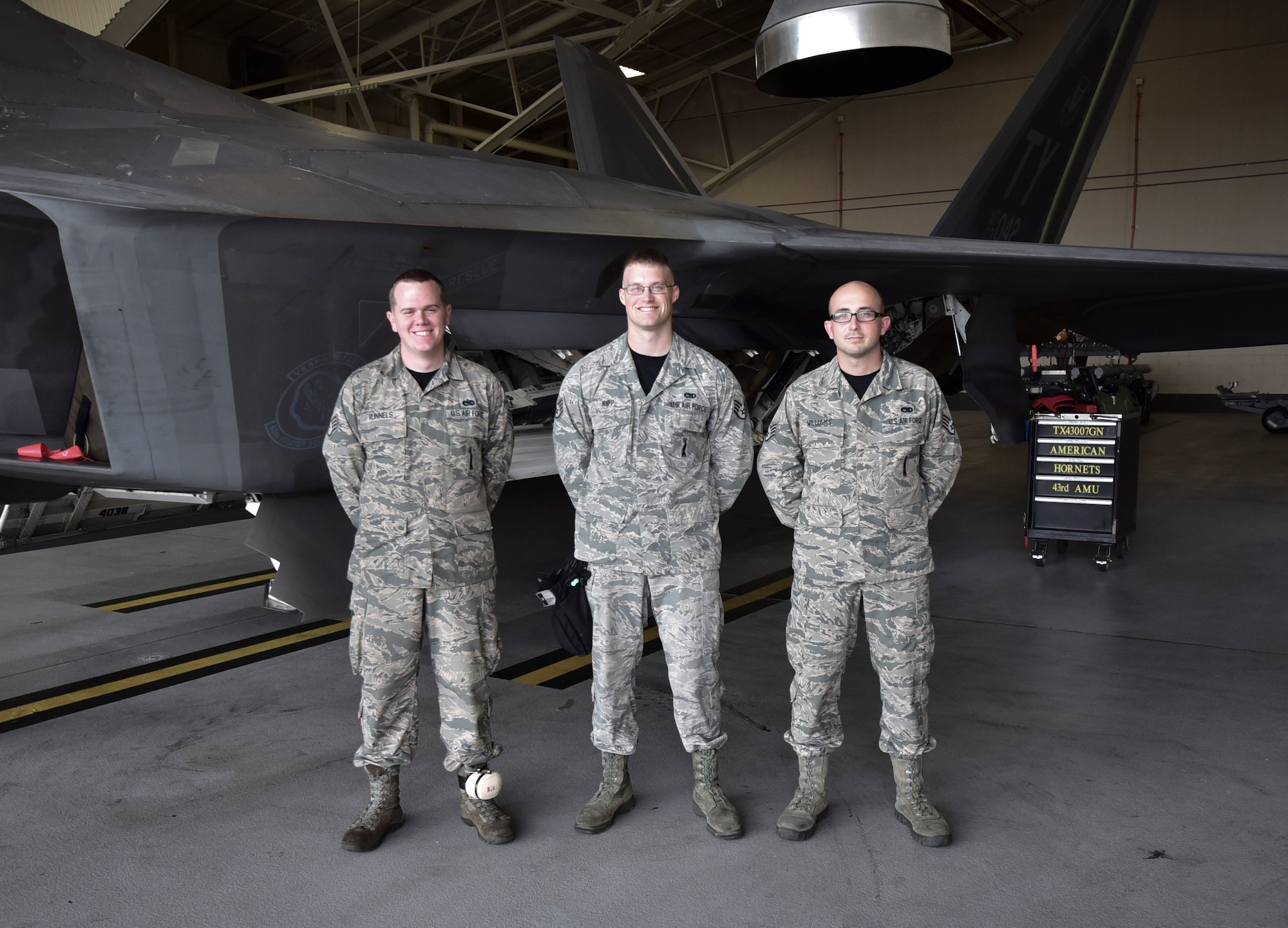 U.S. Air Force Staff Sgts. Nicholas Williams (right), Matthew Runnels (left), and Nicholas Kipp (middle), 43rd Aircraft Maintenance load crew, were announced the winners of the 2016 Weapons Load Crew of the Year competition held at Tyndall Air Force Base, Fla., on Jan. 20, 2017. The trio competed against four other teams of top weapons load crews from each quarter of 2016. (U.S. Air Force photo by Tech. Sgt. Javier Cruz/Released) 