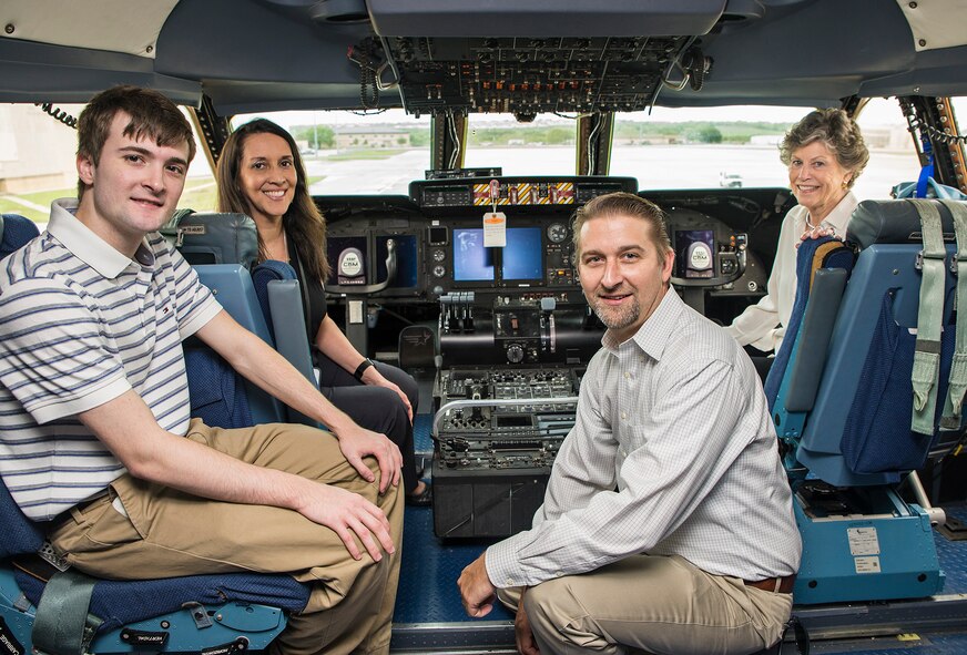 Peggy Marchbanks, the widow of Maj.Gen Tom E. Marchbanks, Jr.,  the first chief, Air Force Reserve, poses for a photo on the flight deck of a C-5M Super Galaxy aircraft with her son Tobin Marchbanks, daughter-inlaw Lorisha Marchbanks, and grandson Colin Marchbanks March 17, 2017 at Joint Base San Antonio-Lackland, Texas. The family recieved a mission brief by Col. Thomas Smith, 433rd Airlift Wing commander, toured the Marchbanks Building dedicated to her late husband, and toured a C-5M aircraft.  (U.S.  Air Force photo by Benjamin Faske)