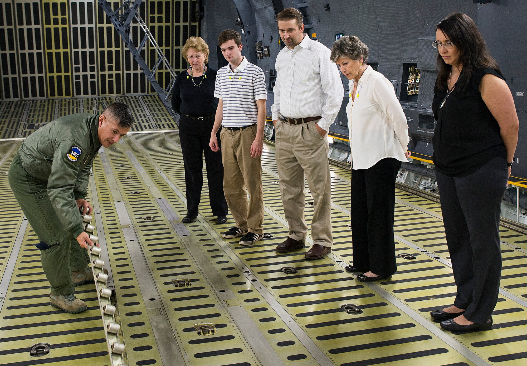 Senior Master Sgt. Miguel Casso, 356th Airlift Squadron load master, shows the Marchbanks family the cargo rollers on a C-5M Super Galaxy aircraft  March 17, 2017 at Joint Base San Antonio-Lackland, Texas. Peggy Marchbanks  was accompanied by her son Tobin Marchbanks, daughter-inlaw Lorisha Marchbanks, grandson Colin Marchbanks, and sister Nancy Richter. She is the widow of Maj.Gen. Tom E. Marchbanks, Jr., the first chief, Air Force Reserve, and former 433rd Airlift Wing commander. (U.S.  Air Force photo by Benjamin Faske)