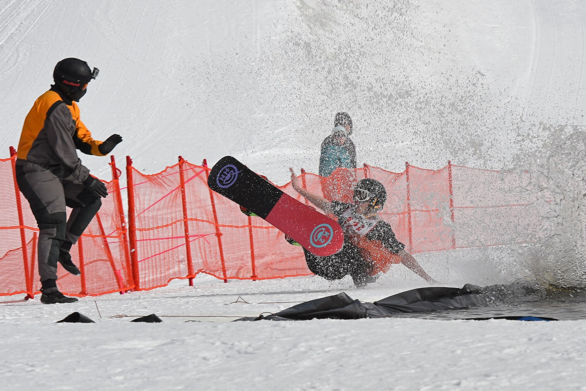 Joint Base Elmendorf-Richardson personnel and families participate in the Slush Cup at the Hillberg Ski Area, March 19, 2017. The Slush Cup is an annual event where skiers and snowboarders try to make it across a slush pond without falling. 
