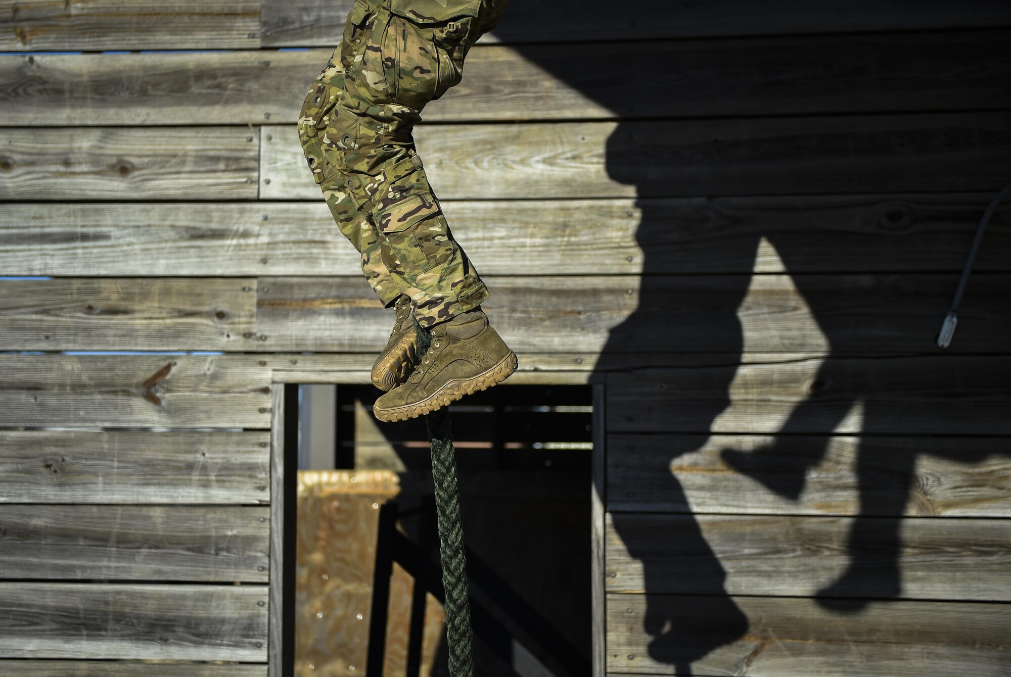 A Soldier with the 1st Battalion, 10th Special Forces Group, fast ropes from a static CV-22 Osprey tiltrotor aircraft frame during training at Hurlburt Field, Fla., March 17, 2017. An instructor with the 1st Special Operations Support Squadron Operational Support Joint Office trained Soldiers on proper fast roping techniques for special operations missions. (U.S. Air Force photo by Airman 1st Class Joseph Pick)