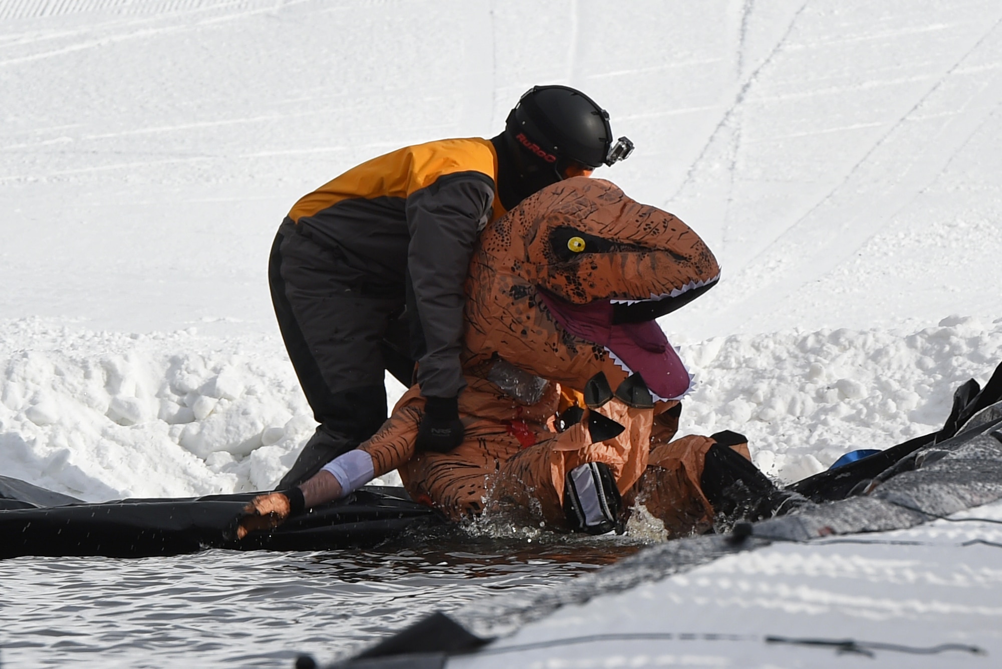 Joint Base Elmendorf-Richardson personnel and families participate in the Slush Cup at the Hillberg Ski Area, March 19, 2017. The Slush Cup is an annual event where skiers and snowboarders try to make it across a slush pond without falling. 