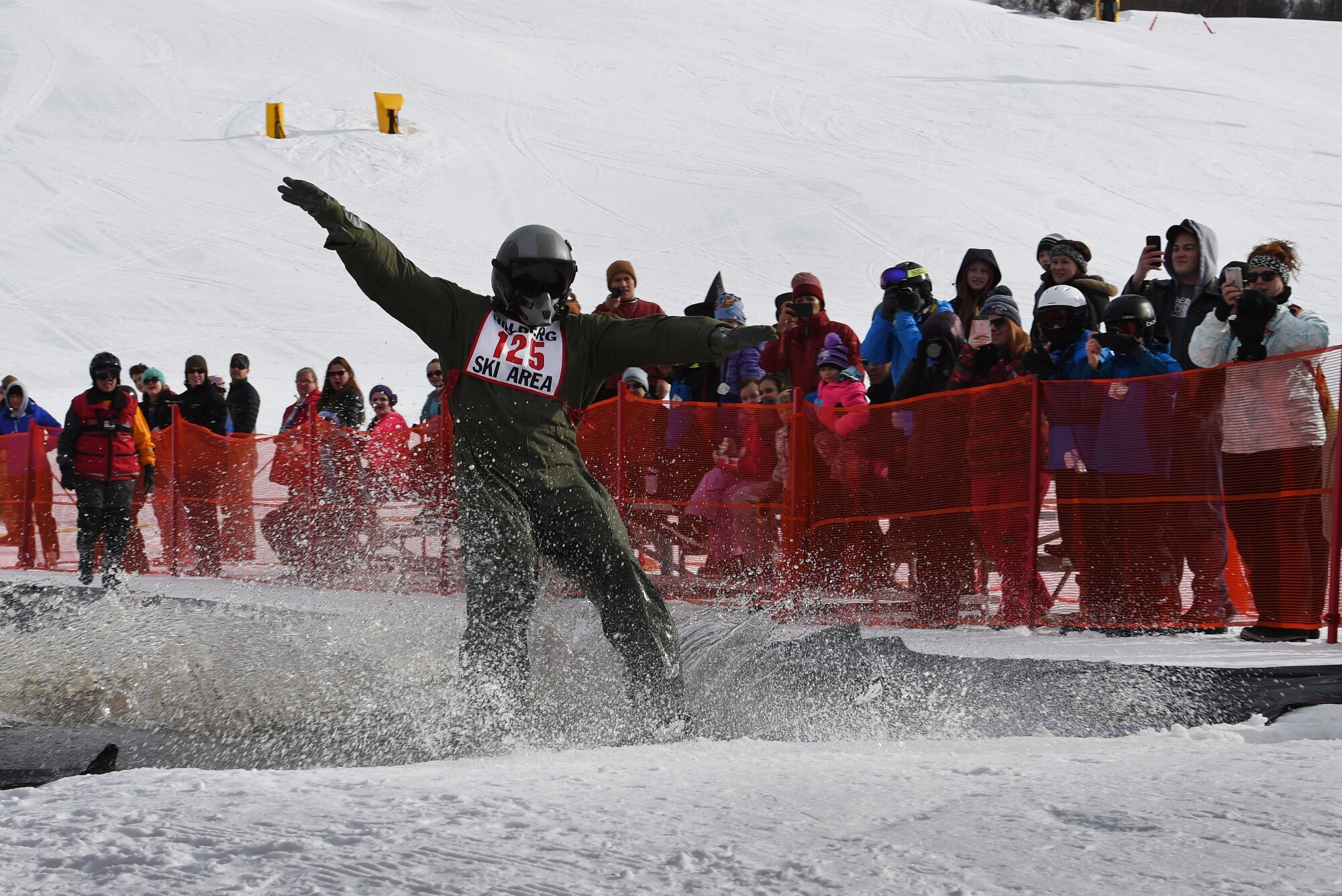 Joint Base Elmendorf-Richardson personnel and families participate in the Slush Cup at the Hillberg Ski Area, March 19, 2017. The Slush Cup is an annual event where skiers and snowboarders try to make it across a slush pond without falling. 