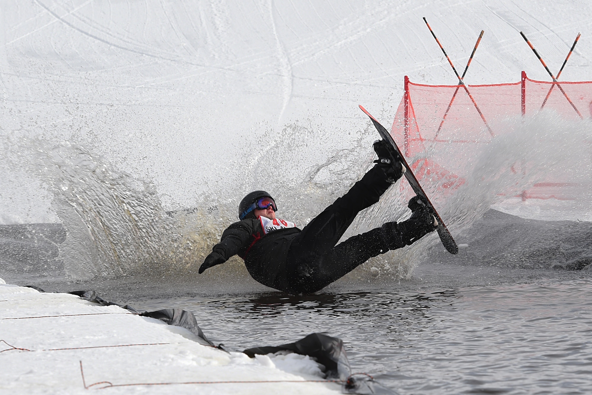 Joint Base Elmendorf-Richardson personnel and families participate in the Slush Cup at the Hillberg Ski Area, March 19, 2017. The Slush Cup is an annual event where skiers and snowboarders try to make it across a slush pond without falling. 