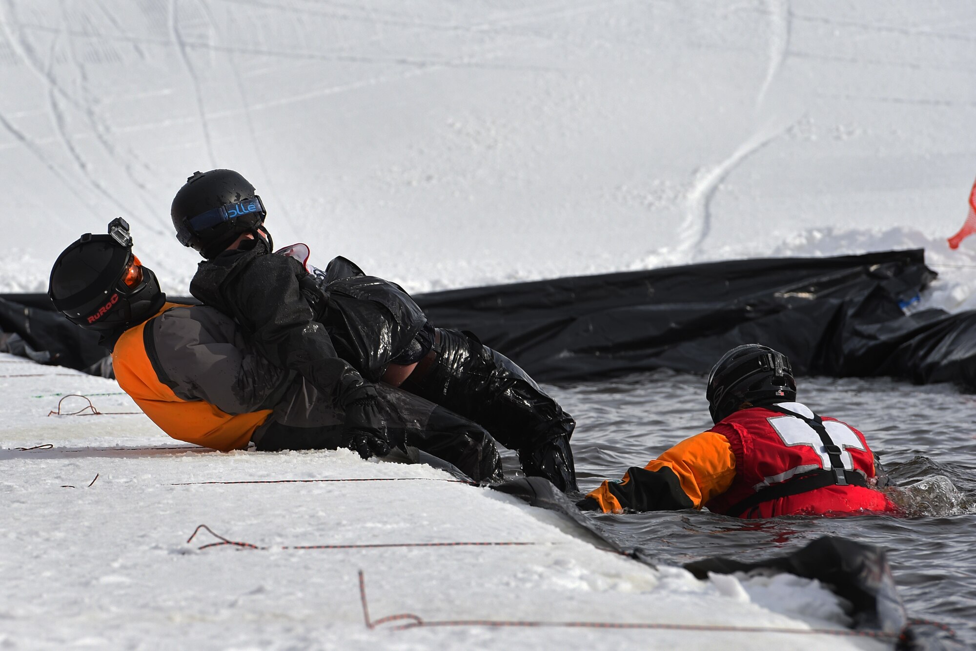 Joint Base Elmendorf-Richardson personnel and families participate in the Slush Cup at the Hillberg Ski Area, March 19, 2017. The Slush Cup is an annual event where skiers and snowboarders try to make it across a slush pond without falling. 