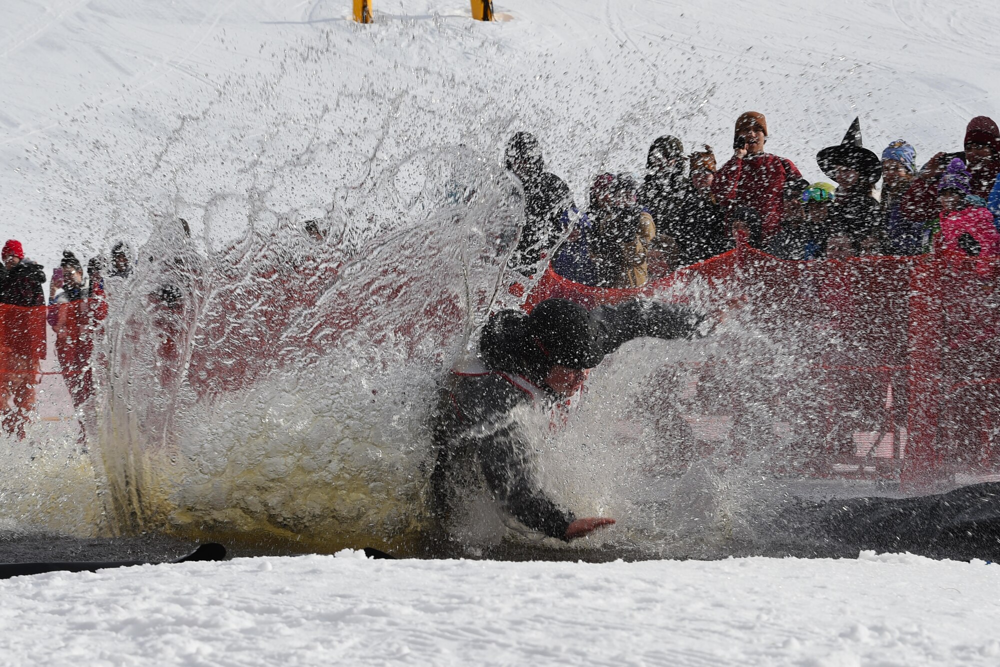 Joint Base Elmendorf-Richardson personnel and families participate in the Slush Cup at the Hillberg Ski Area, March 19, 2017. The Slush Cup is an annual event where skiers and snowboarders try to make it across a slush pond without falling. 