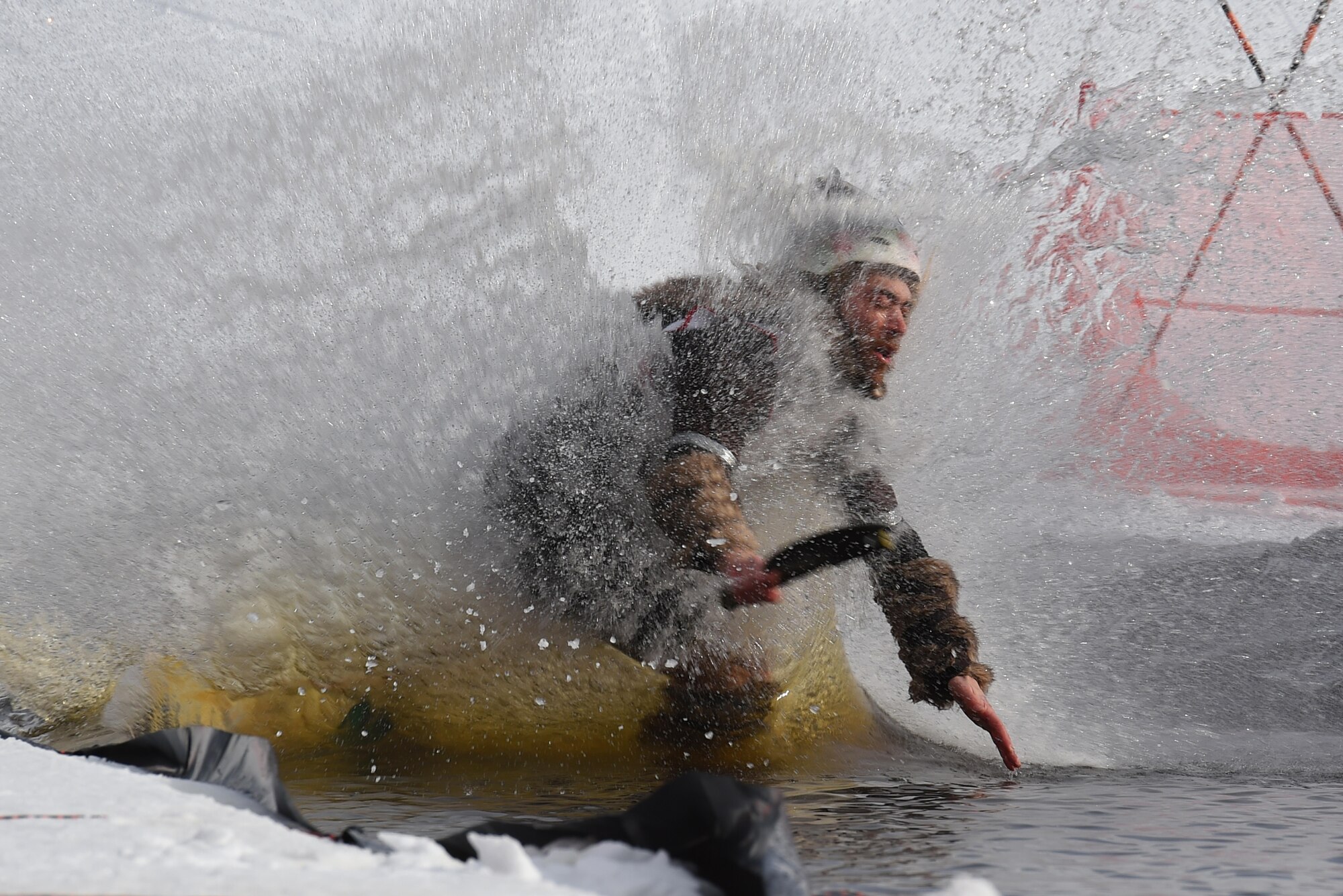Joint Base Elmendorf-Richardson personnel and families participate in the Slush Cup at the Hillberg Ski Area, March 19, 2017. The Slush Cup is an annual event where skiers and snowboarders try to make it across a slush pond without falling. 