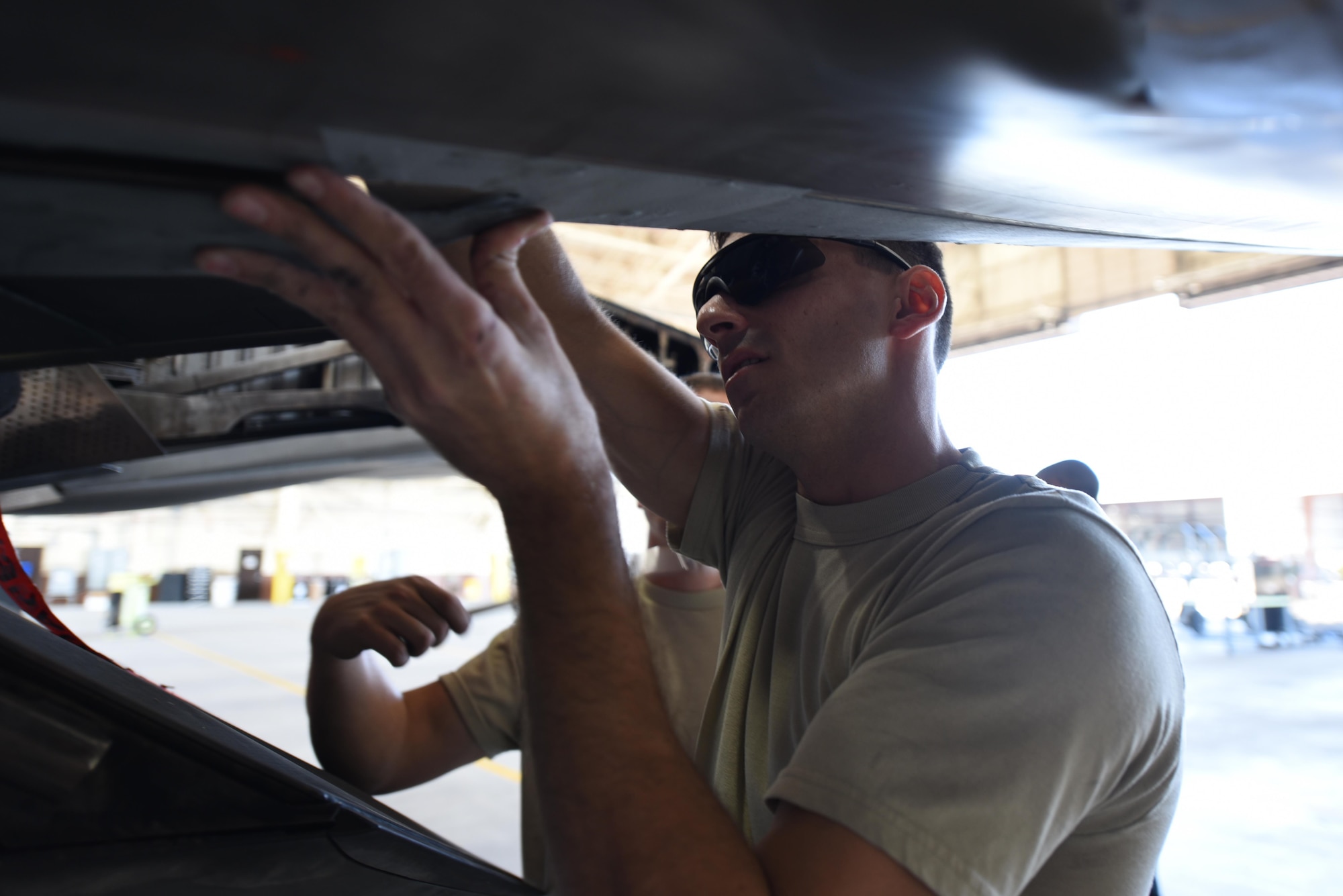 U.S. Air Force Tech. Sgt. Robert Mackle, 325th Aircraft Maintenance Squadron dedicated crew chief, attaches a panel to an F-22 Raptor in Hangar 2 at Tyndall Air Force Base, Fla., March 20, 2017. Throughout the course of a day, dedicated crew chiefs like Mackle inspect and maintain the aircraft of the 95th Fighter Squadron prior to pilots’ takeoff for training. (U.S. Air Force photo by Senior Airman Solomon Cook/Released)