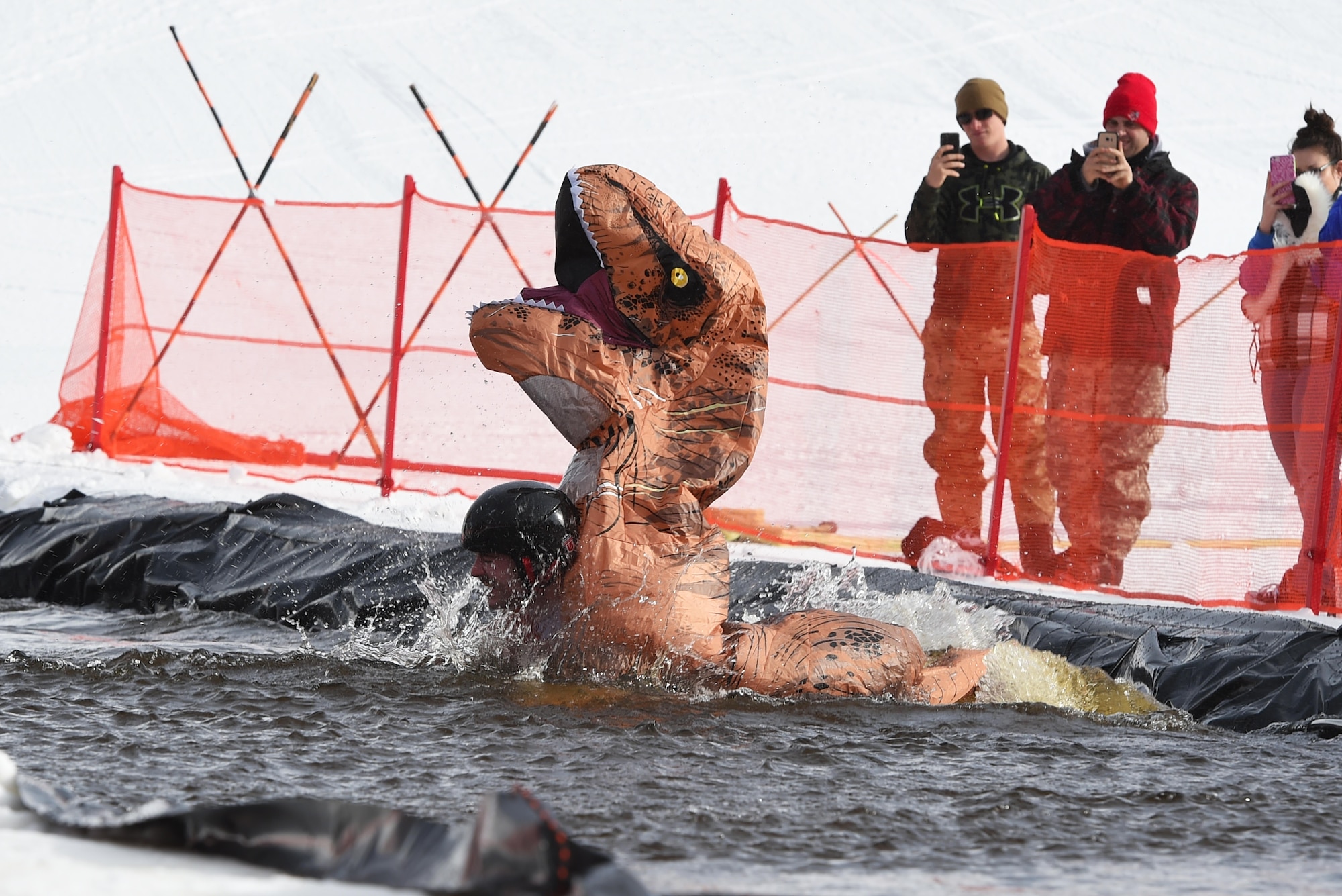 Joint Base Elmendorf-Richardson personnel and families participate in the Slush Cup at the Hillberg Ski Area, March 19, 2017. The Slush Cup is an annual event where skiers and snowboarders try to make it across a slush pond without falling. 