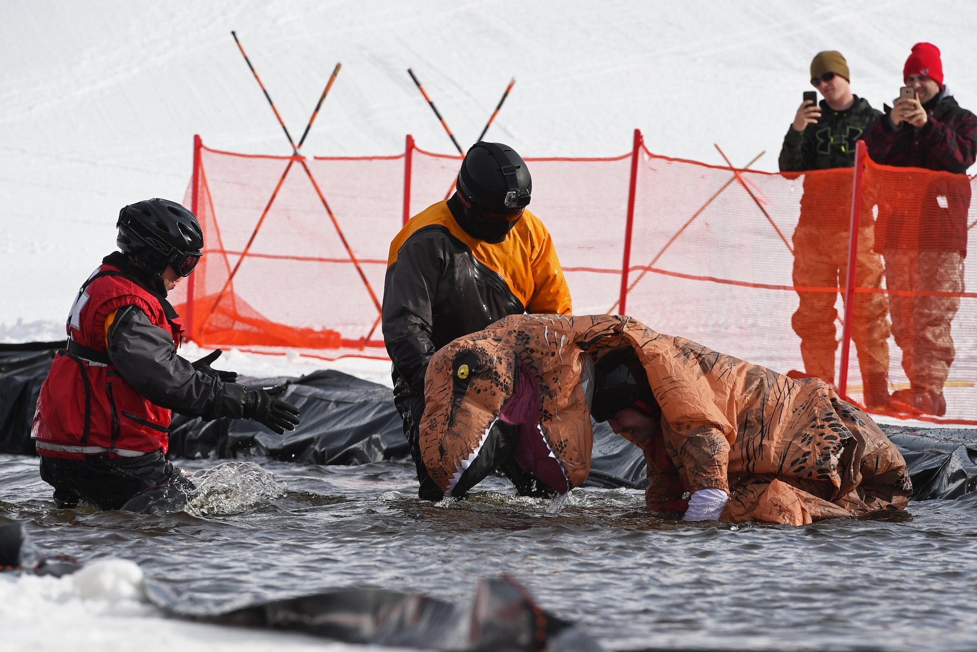 Joint Base Elmendorf-Richardson personnel and families participate in the Slush Cup at the Hillberg Ski Area, March 19, 2017. The Slush Cup is an annual event where skiers and snowboarders try to make it across a slush pond without falling. 