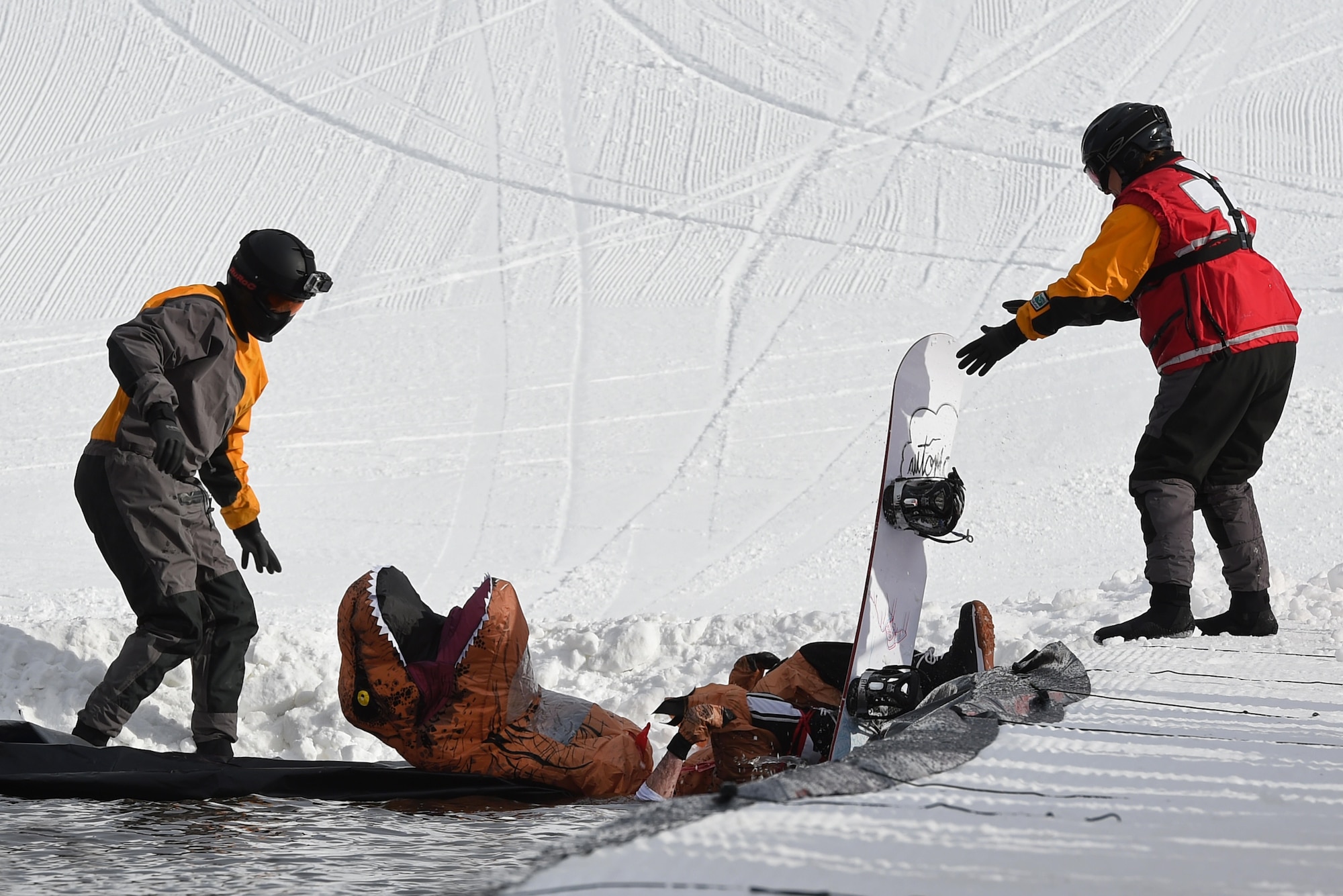 Joint Base Elmendorf-Richardson personnel and families participate in the Slush Cup at the Hillberg Ski Area, March 19, 2017. The Slush Cup is an annual event where skiers and snowboarders try to make it across a slush pond without falling. 