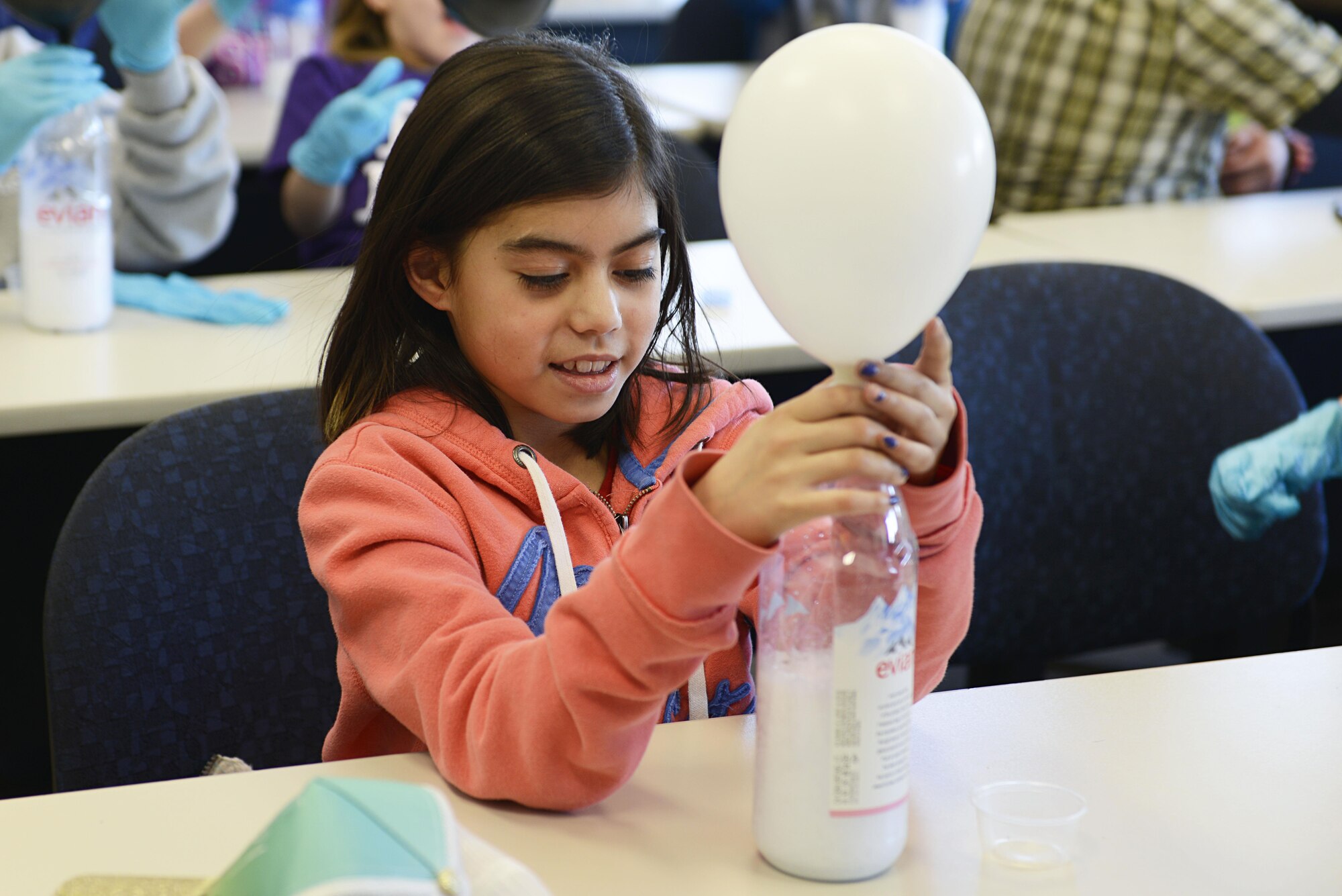 Breanna Coyle, 10, fills a balloon with the gas created from a chemical reaction between vinegar and baking soda during the Spring Break Science Program at the Joint Base Elmendorf-Richardson Library, March 17, 2017. The program offered various interactive experiments and activities revolving around science for children during the week of spring break. 