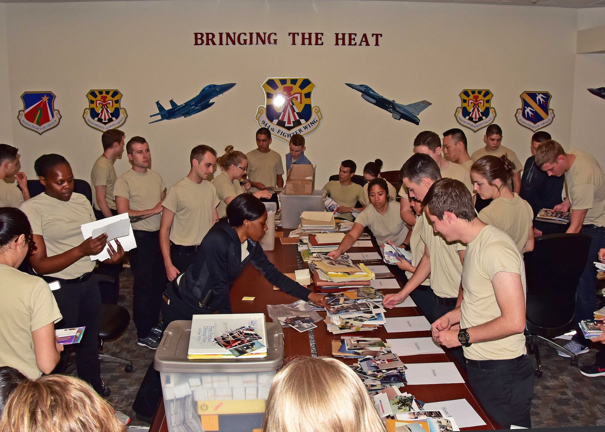 Members from the 944th Fighter Wing Development Training Flight, work to look through and organize photos for the 944 FW Historian office Mar. 4 here at Luke Air Force Base, Ariz. (U.S. Air Force photo by Tech. Sgt. Louis Vega Jr.)