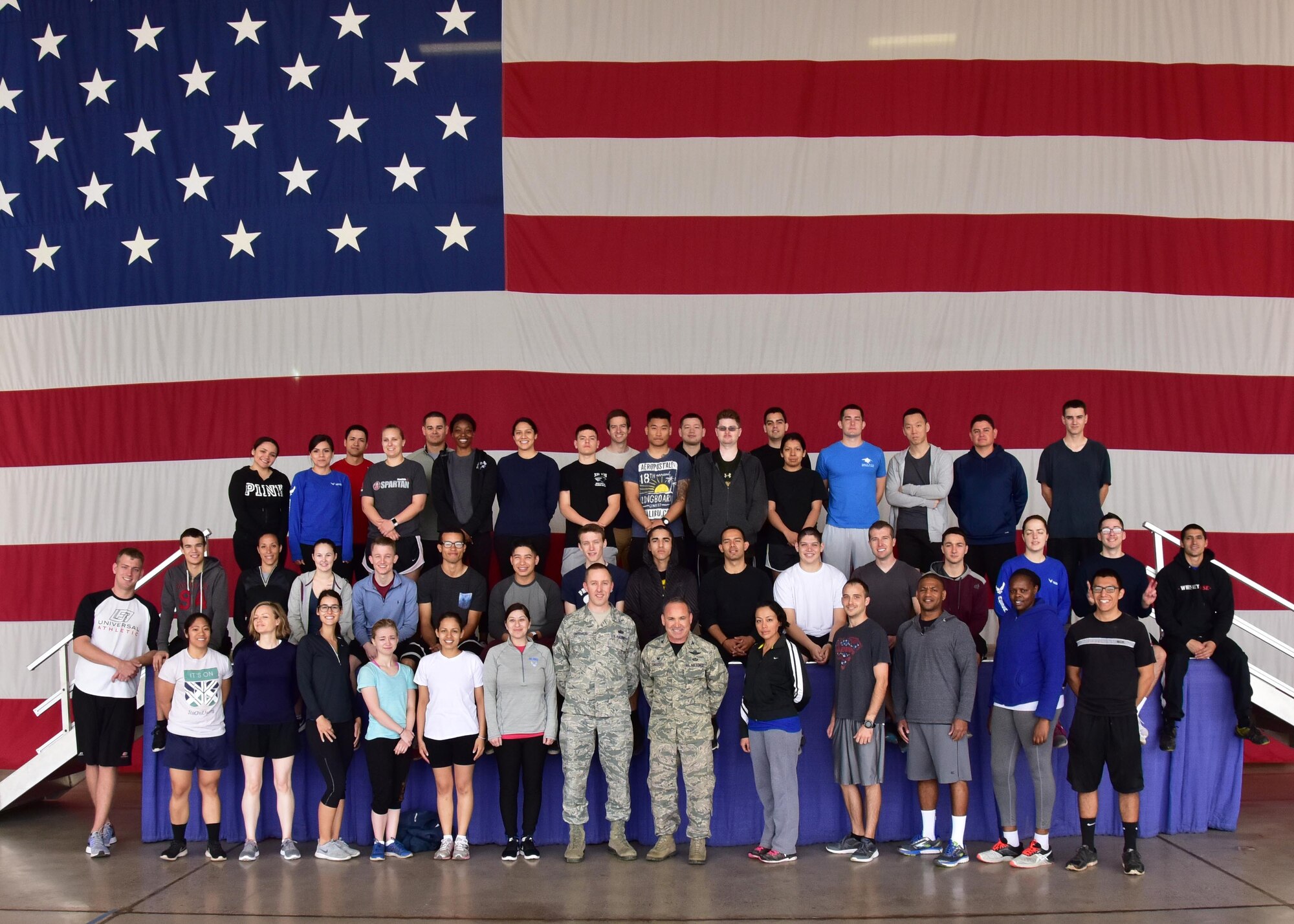 Members from the 944th Fighter Wing Development Training Flight pose for a group photo with Col. Kurt Gallegos, 944 FW commander, during the March unit training assembly at Luke Air Force Base, Ariz. (U.S. Air Force photo by Tech. Sgt. Louis Vega Jr.)