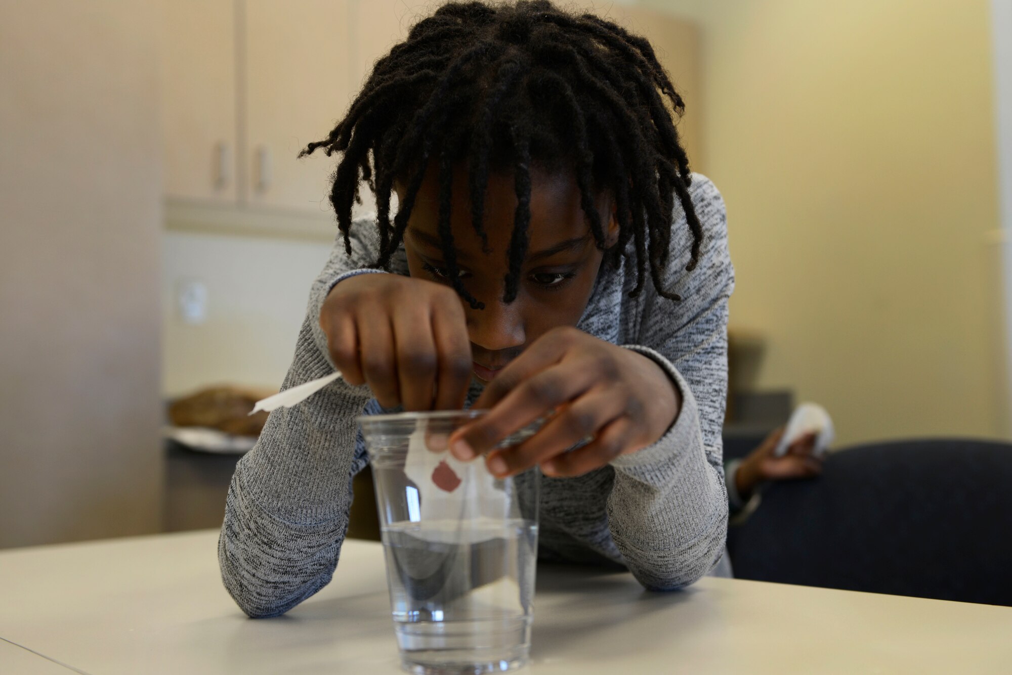London George, 7, participates in an experiment during the Spring Break Science Program at the Joint Base Elmendorf-Richardson Library, March 17, 2017. The program offered various interactive experiments and activities revolving around science for children during the week of spring break. 