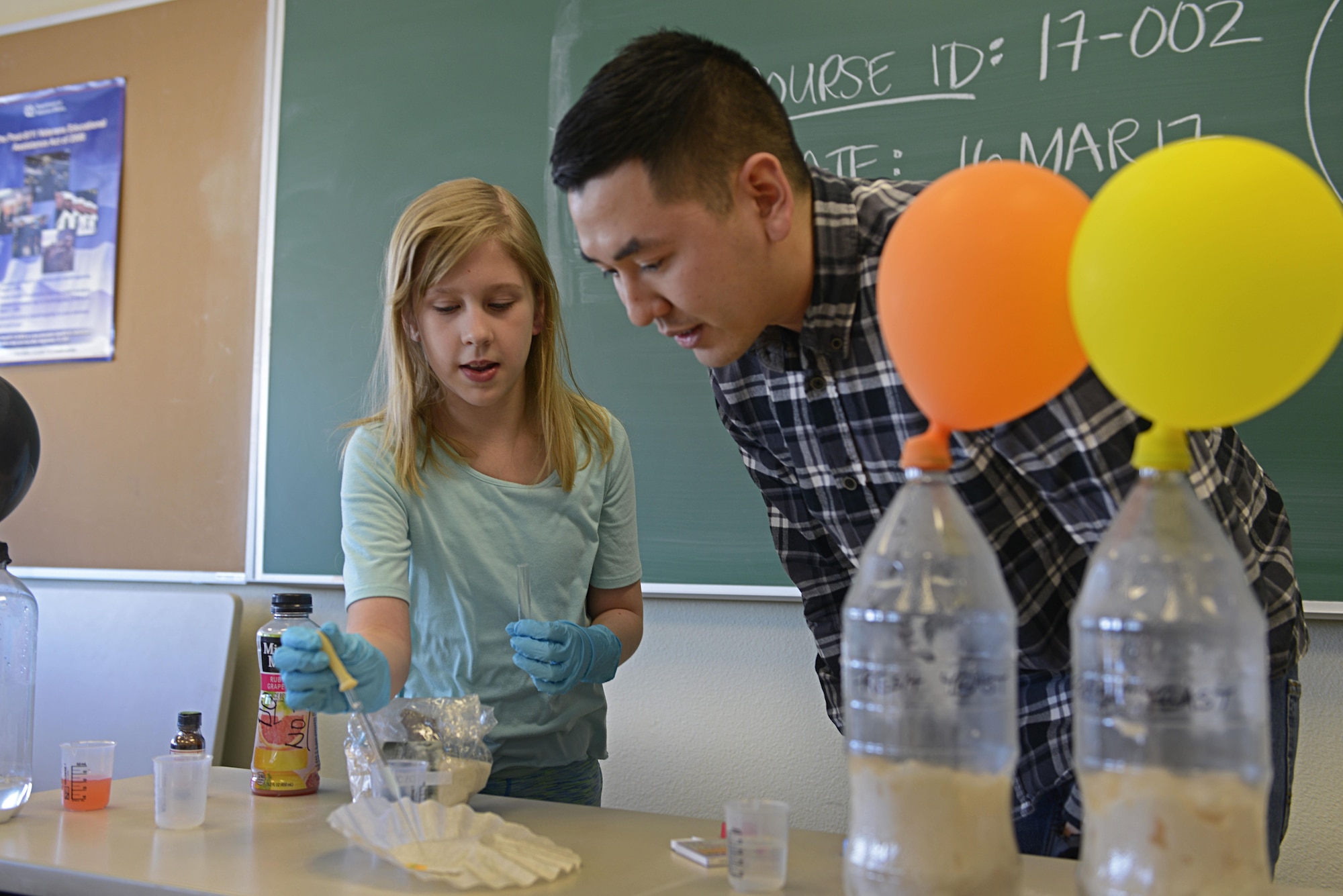 Katelyn Diamond, 10, and Army 2nd Lt. Roger Tran, 103rd Civil Support Team nuclear medical science officer, test the acidity levels of lemon juice during the Spring Break Science Program at the Joint Base Elmendorf-Richardson Library, March 17, 2017. The program offered various interactive experiments and activities revolving around science for children during the week of spring break. 