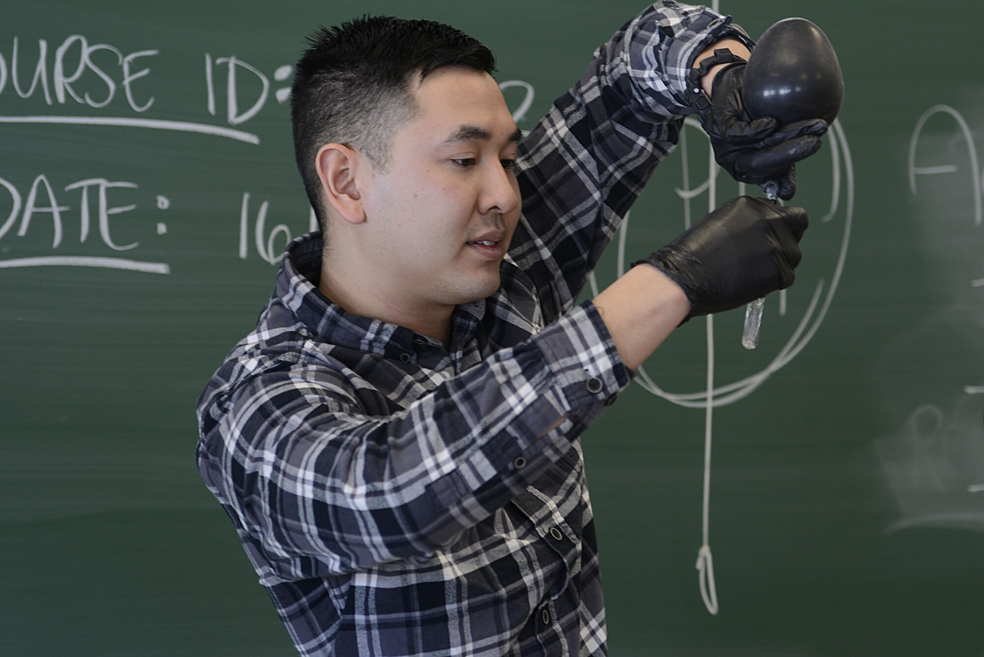 Army 2nd Lt. Roger Tran, 103rd Civil Support Team nuclear medical science officer, demonstrates a chemical reaction during the Spring Break Science Program at the Joint Base Elmendorf-Richardson Library, March 17, 2017. The program offered various interactive experiments and activities revolving around science for children during the week of spring break. 
