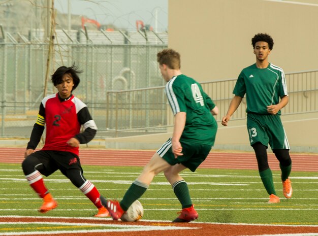 An Edgren High School soccer player from Misawa Air Base attempts to out maneuver an E.J. King High School soccer player from Sasebo, during the Perry Cup Soccer Tournament 2017 at Marine Corps Air Station Iwakuni, Japan, March 18, 2017. Edgren won the game against E.J. King after a 1-1 tie and an overtime penalty kick shootout. (U.S. Marine Corps photo by Pfc. Stephen Campbell)