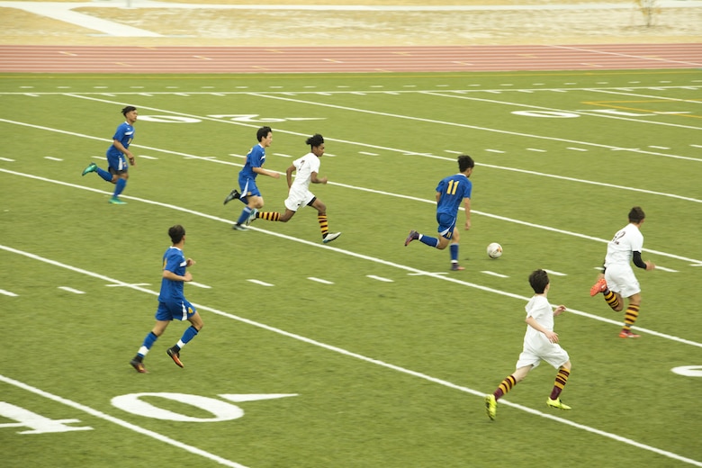 A player from the Yokota High School soccer team out of Yokota Air Force Base kicks a soccer ball down the field to score a goal against Matthew C. Perry High School soccer team during the Perry Cup Soccer Tournament 2017 at Marine Corps Air Station Iwakuni, Japan, March 18, 2017. Yokota beat M.C. Perry 1-0 and won second place in the Maroon Group. (U.S. Marine Corps photo by Pfc. Stephen Campbell)