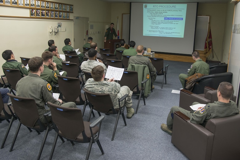 U.S. Air Force and Japan Air Self-Defense Force pilots sit in a dissimilar air combat-training brief at Misawa Air Base, Japan, March 17, 2017. During the brief, personnel discussed any mistakes, communication problems and tactic differences that occurred during the mission. (U.S. Air Force photo by Senior Airman Jarrod Vickers)