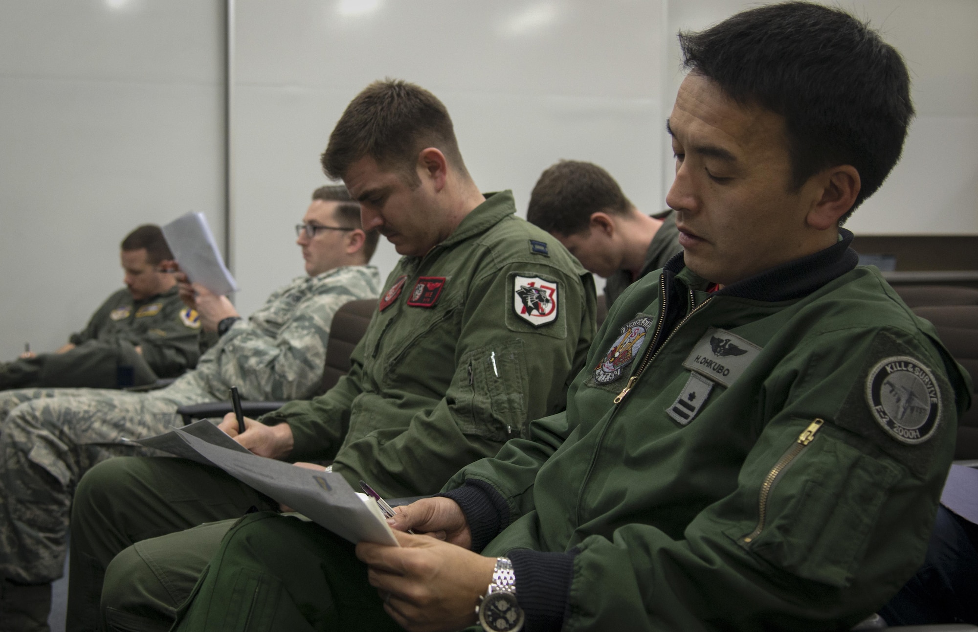U.S. Air Force and Japan Air Self-Defense Force pilots sit through a dissimilar air combat-training brief at Misawa Air Base, Japan, March 17, 2017. The DAC-T allows for U.S. and JASDF pilots to identify any potential errors in their tactics, as well as visualize how working with other nations will be like during large force exercises. (U.S. Air Force photo by Senior Airman Jarrod Vickers)