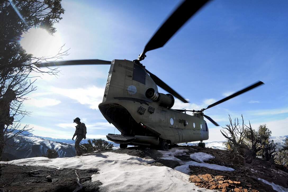 Soldiers walk around their CH-47F Chinook helicopter after landing on a mountaintop during high-altitude flight operations near Vail, Colo,, March 10, 2017. The soldiers are assigned to the South Carolina Army National Guard's Company B, 2nd Battalion, 238th General Support Aviation Regiment. Army National Guard photo by Staff Sgt. Roberto Di Giovine

