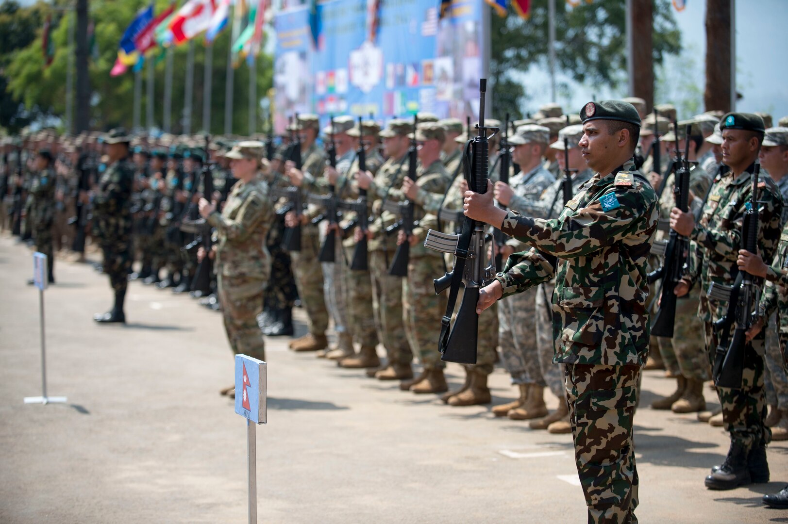 Multiple partner nations present arms in formation during the opening ceremony of exercise Shanti Prayas III in Nepal.  Shanti Prayas III is a multinational United Nations peacekeeping exercise designed to provide pre-deployment training to U.N. partner countries in preparation for real-world peacekeeping operations. (U.S. Navy Photo by Petty Officer 2nd Class Taylor Mohr)