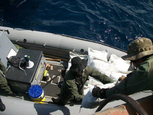Sailors assigned to USS Laboon (DDG 58) offload bags containing Hashish from a dhow in the Arabian Sea, March 17. Laboon Sailors intercepted the dhow and seized 500 kg of Hashish, their second successful drug interdiction operation in five days. Laboon, operating as part of Combined Task Force (CTF) 150, is attached to Destroyer Squadron (DESRON) 22.