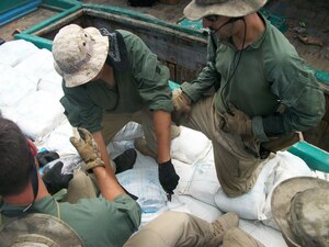 Sailors assigned to USS Laboon (DDG 58) inspect bags containing Hashish during an inspection of a dhow in the Arabian Sea, March 17. Laboon Sailors intercepted the dhow and seized 500 kg of Hashish, their second successful drug interdiction operation in five days. Laboon, operating as part of Combined Task Force (CTF) 150, is attached to Destroyer Squadron (DESRON) 22. 