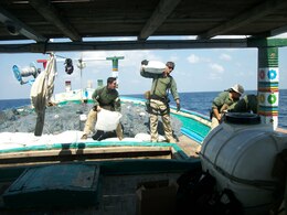 Sailors assigned to USS Laboon (DDG 58) offload bags containing Hashish from a dhow in the Arabian Sea, March 17. Laboon Sailors intercepted the dhow and seized 500 kg of Hashish, their second successful drug interdiction operation in five days. Laboon, operating as part of Combined Task Force (CTF) 150, is attached to Destroyer Squadron (DESRON) 22. 