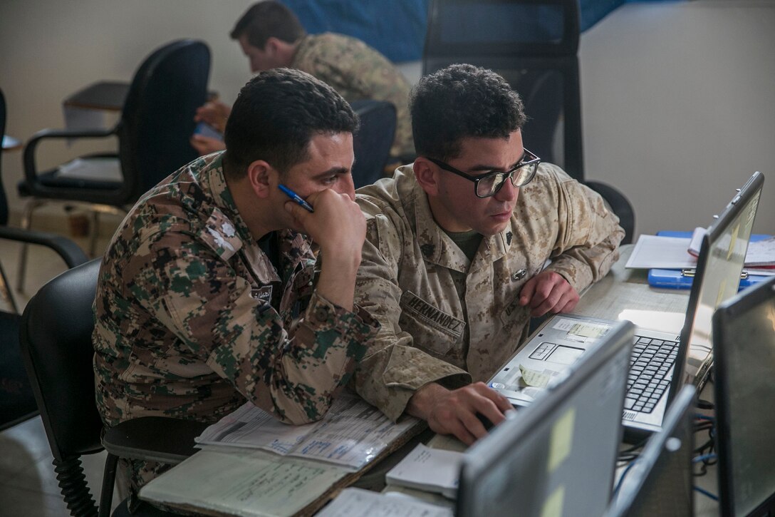 U.S. Marine Sgt. Evan Hernandez, a radio operator with 4th Air/Naval Gunfire Liaison Company Detachment, Special Purpose Marine Air-Ground Task Force – Crisis Response – Central Command, trains on a close air support simulator with a Jordanian officer while in Jordan, Feb. 12, 2017. U.S. Marines train with coalition partners to enhance each other’s skills and knowledge in support of mutual objectives while meeting common security challenges. (U.S. Marine Corps photo by Lance Cpl. Kyle McNan) 