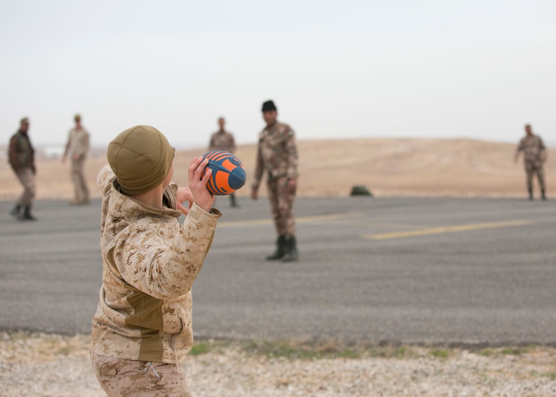 U.S. Marine Cpl. Matthew Boys, a fire support Marine with 3rd Battalion, 7th Marine Regiment, Special Purpose Marine Air Ground Task Force – Crisis Response – Central Command, plays American football with Jordanian troops while in Jordan, Feb. 22, 2017. A blending of cultures and the strong bond shared with partner militaries highlights our enduring partnership and support for mutual objectives while meeting common security challenges. (U.S. Marine Corps photo by Lance Cpl. Kyle McNan) 