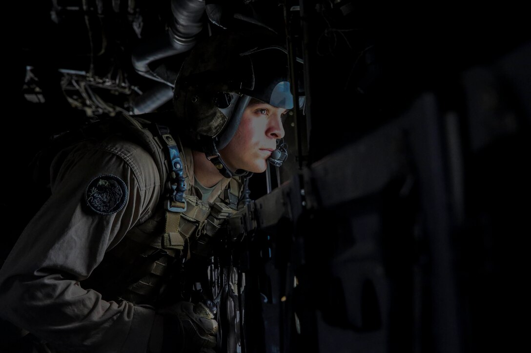 Sgt. Mark Hernandez, a crew chief with Marine Medium Tiltrotor Squadron 165, Special Purpose Marine Air-Ground Task Force-Crisis Response-Central Command, assesses the drop area from the window of an MV-22B Osprey tiltrotor aircraft during an air delivery training exercise while forward deployed in the Middle East, March 9, 2017. The training served as an opportunity for the VMM-165 aircrew to increase their proficiency in aerial cargo delivery. SPMAGTF-CR-CC is a well-trained crisis response unit that has the ability to project combat power over vast distances using organic aviation, logistical and ground combat assets. (U.S. Marine Corps photo by Lance Cpl. Shellie Hall) 