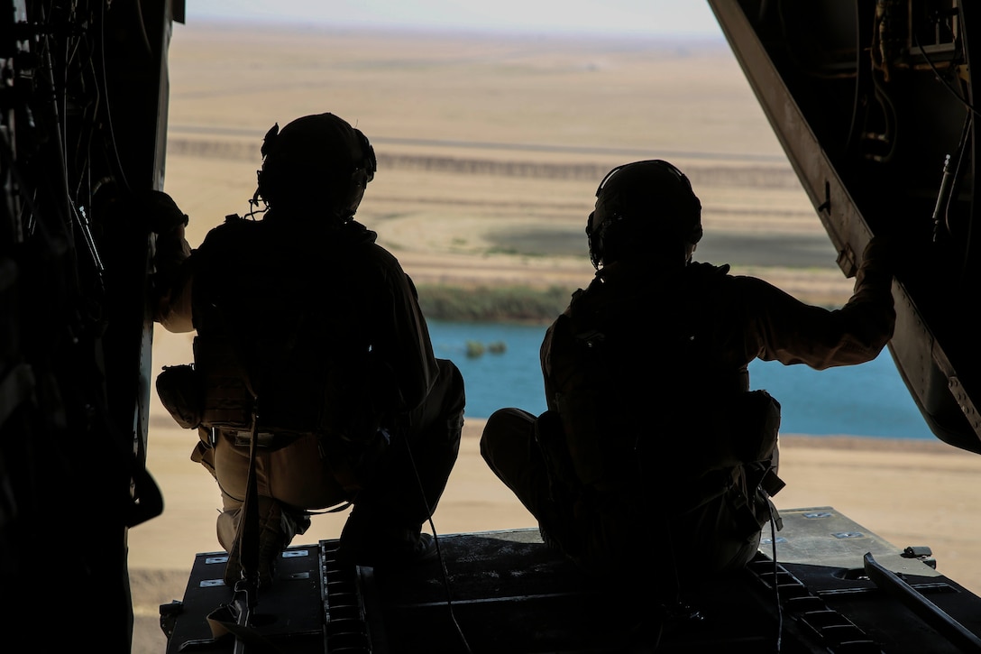 Sgt. Mark Hernandez and Sgt. Branden Shaw, crew chiefs with Marine Medium Tiltrotor Squadron 165, Special Purpose Marine Air-Ground Task Force-Crisis Response-Central Command, observe the cargo drop from the ramp of an MV-22B Osprey tiltrotor aircraft during an air delivery training exercise while forward deployed in the Middle East, March 9, 2017. The training served as an opportunity for the VMM-165 aircrew to increase their proficiency in aerial cargo delivery. SPMAGTF-CR-CC is a well-trained crisis response unit that has the ability to project combat power over vast distances using organic aviation, logistical and ground combat assets. (U.S. Marine Corps photo by Lance Cpl. Shellie Hall) 