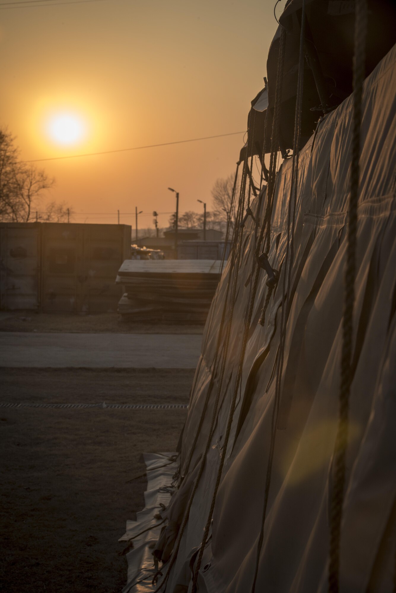 A tent’s ropes used to secure the weather fly whip around in the evening’s breeze in the Rush Park life support area at Osan Air Base, Republic of Korea, March 14, 2017. Rush Park is home to 24 tents and several K-span buildings. Each tent can house up to 20 personnel and the K-spans have room for 120 personnel. The LSA’s Services Sustainment Flight arrived about a week before the main body involved with Key Resolve 2017. From boots on the ground, the LSA’s construction took just 72 hours to build and ready to receive the first bus load of personnel. (U.S. Air Force photo by Staff Sgt. Benjamin W. Stratton)