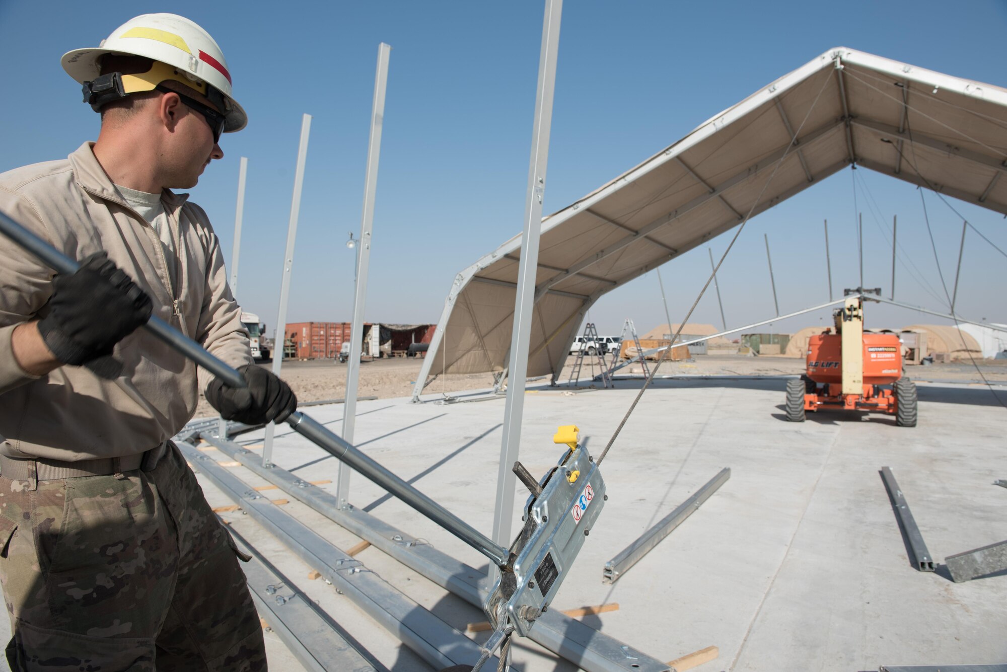 Staff Sgt. Ryan Mendenhall, 577th Expeditionary Prime Beef Squadron electrical systems specialist, increases the tension on a pulley to raise the arch of a 4K dome at the 407th Air Expeditionary Group, March 21, 2017. Mendenhall was part of a team, which forward deployed to assist the 407th Expeditionary Civil Engineer Squadron with erecting large structures on base.  (U.S. Air Force photo/Master Sgt. Benjamin Wilson)(Released)