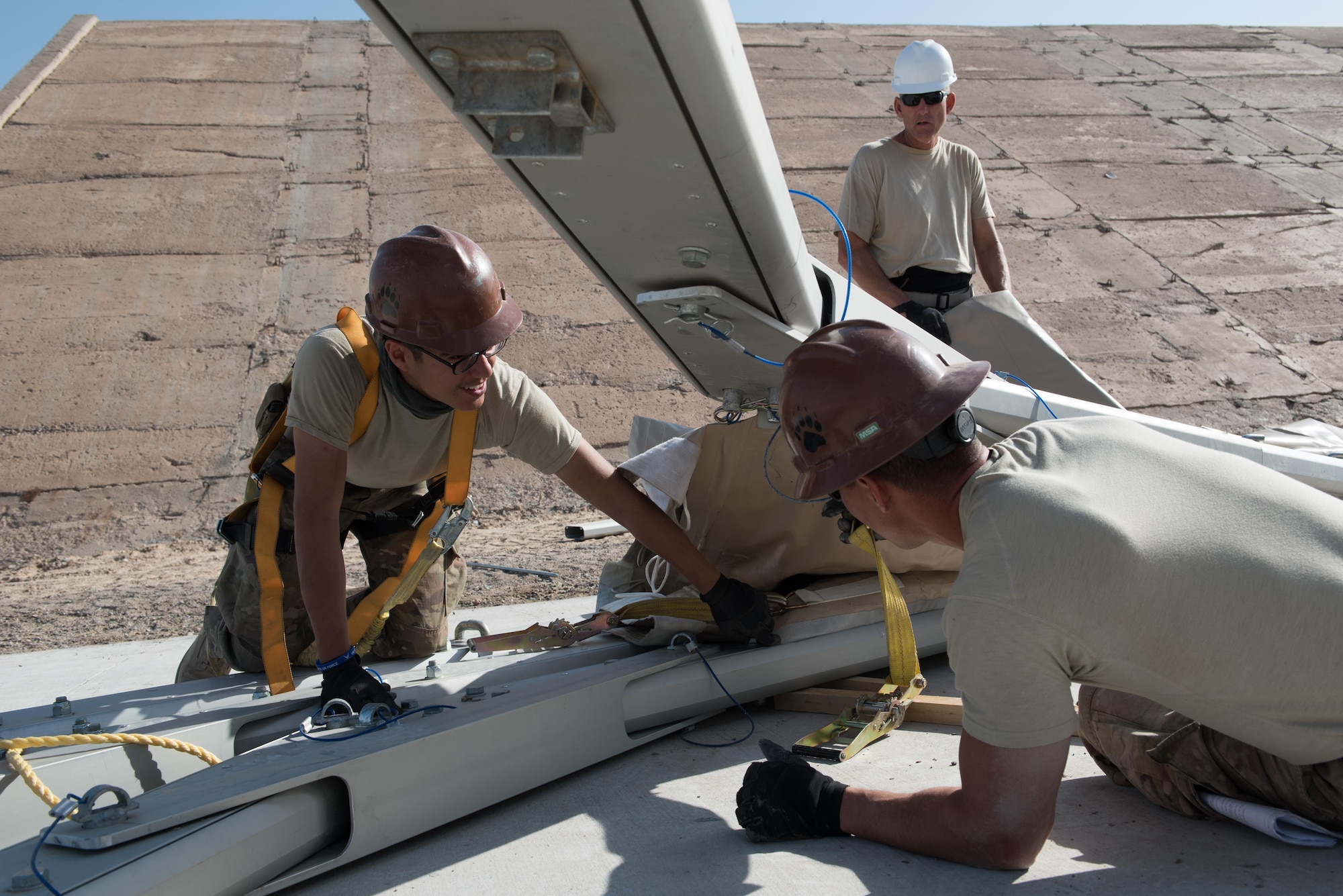 Airmen assigned to the 407th Expeditionary Civil Engineer Squadron and 577th Expeditionary Prime Beef Squadron install canvas on a new 4k dome at the 407th Air Expeditionary Group, March 21, 2017. The new structure will provide 4,000 square feet of covered area to maintain vehicles operating in support of Operation Inherent Resolve. (U.S. Air Force photo/Master Sgt. Benjamin Wilson)(Released)