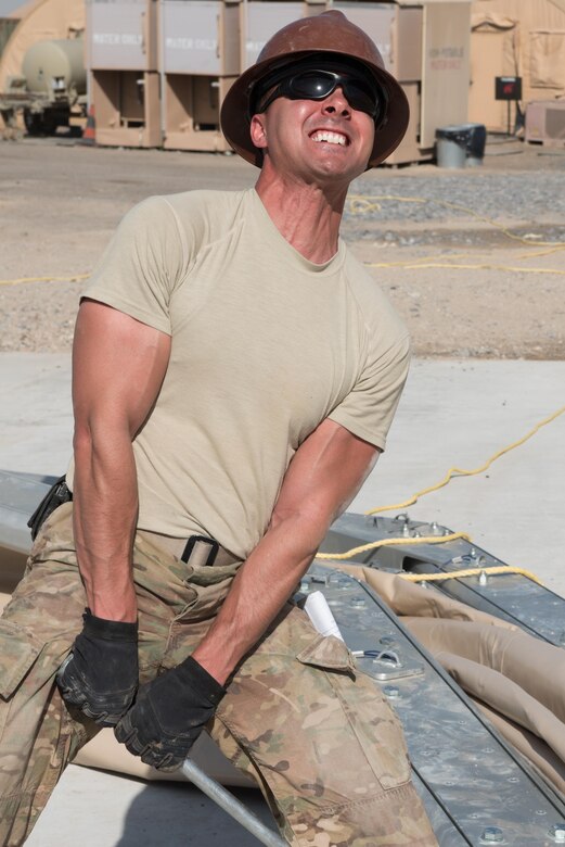 Staff Sgt. Dustin Brooks, 577th Expeditionary Prime Beef Squadron structures craftsman, uses a pry bar to raise an arch on a 4k dome while installing its canvas covering at the 407th Air Expeditionary Group, March 21, 2017. Brooks was part of a team, which forward deployed to assist the 407th Expeditionary Civil Engineer Squadron with erecting large structures on base. (U.S. Air Force photo/Master Sgt. Benjamin Wilson)(Released)