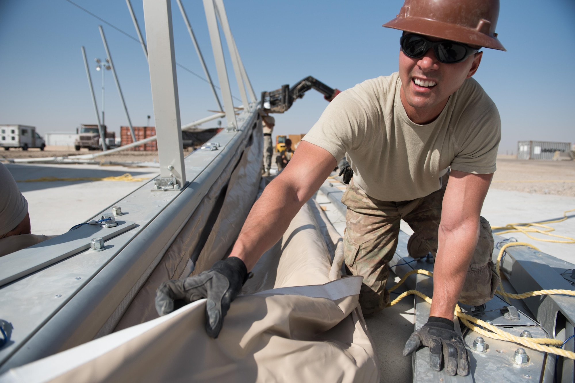 Staff Sgt. Dustin Brooks, 577th Expeditionary Prime Beef Squadron structures craftsman, installs canvas onto a 4k dome at the 407th Air Expeditionary Group, March 21, 2017. Brooks was part of a team, which forward deployed to assist the 407th Expeditionary Civil Engineer Squadron with erecting large structures on base. (U.S. Air Force photo/Master Sgt. Benjamin Wilson)(Released)