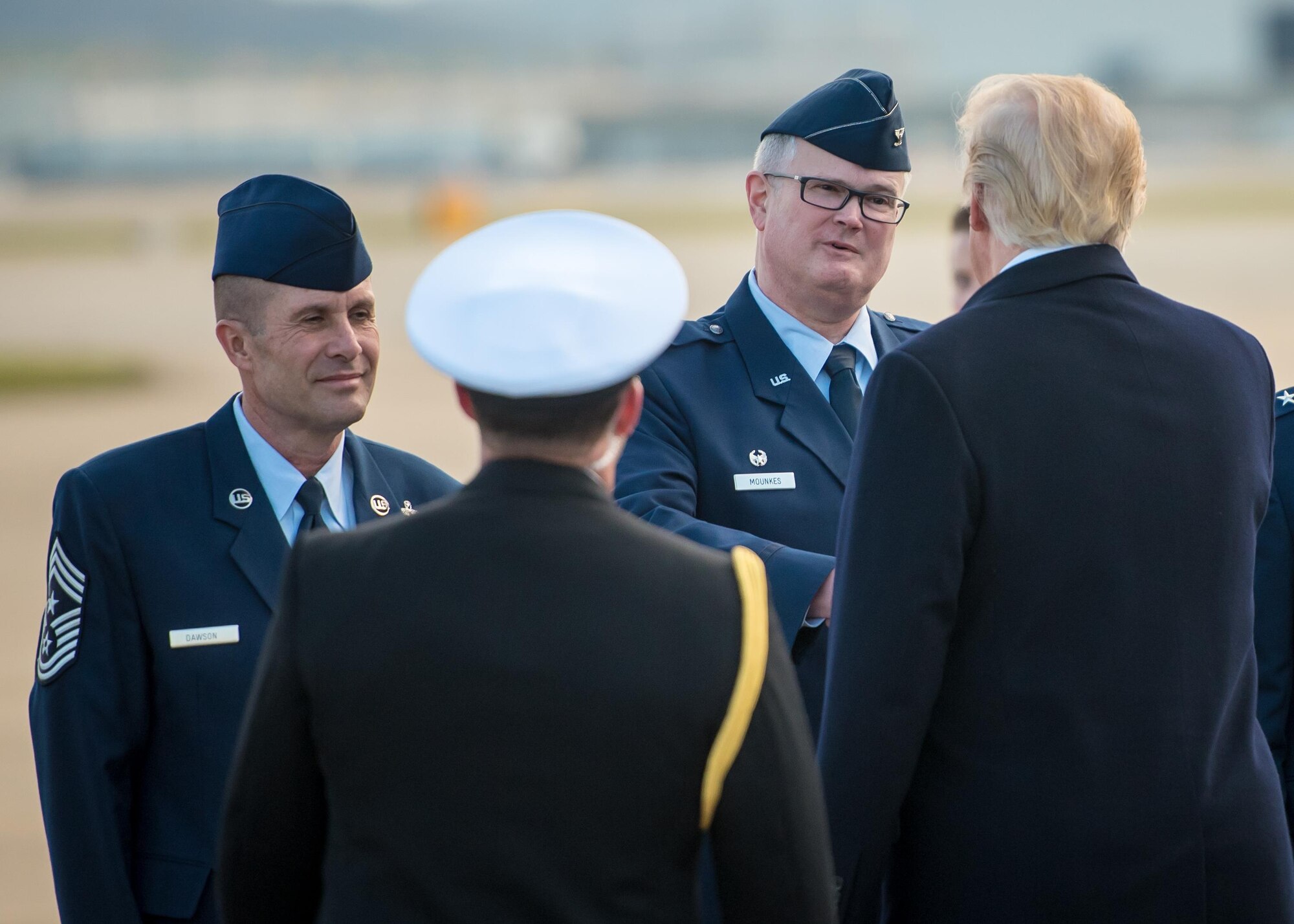 Col. David Mounkes (second from right), commander of the 123rd Airlift Wing, and Chief Master Sgt. Ray Dawson (left), wing command chief, greet President Donald Trump as he arrives at the Kentucky Air National Guard Base in Louisville, Ky., March 20, 2017. Trump was in Louisville to attend a rally at the Kentucky Exposition Center. (U.S. Air National Guard photo by Master Sgt. Phil Speck)
