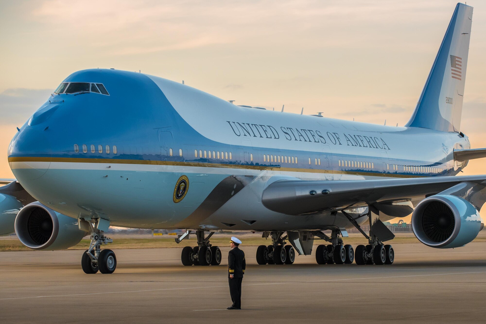 President Donald Trump arrives at the Kentucky Air National Guard Base in Louisville, Ky., March 20, 2017 as a naval officer stands by to render a salute. Trump was in Louisville to attend a campaign rally at the Kentucky Exposition Center. (U.S. Air National Guard photo by Lt. Col. Dale Greer)