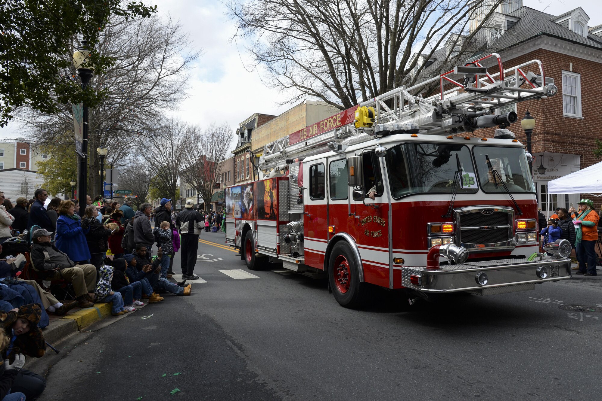 A firetruck assigned to the 436th Civil Engineer Squadron brings up the rear of the St. Patrick’s Day Parade March 18, 2017, in Downtown Dover, Del. According to the Downtown Dover Partnership, the turnout for the parade was the largest the city has ever seen. (U.S. Air Force photo by Senior Airman Aaron J. Jenne)