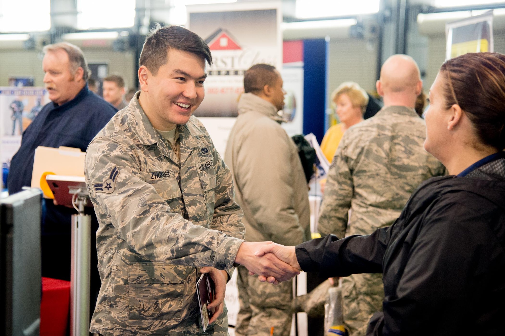 Airman 1st Class Beknazar Zhumabaev, 436th Logistics Readiness Squadron vehicle operator, meets with potential employers at a job fair during the Transition Summit March 16, 2017, at Dover Air Force Base, Del. The summit also featured resume building workshops and a spouse symposium. (U.S. Air Force photo by Mauricio Campino)