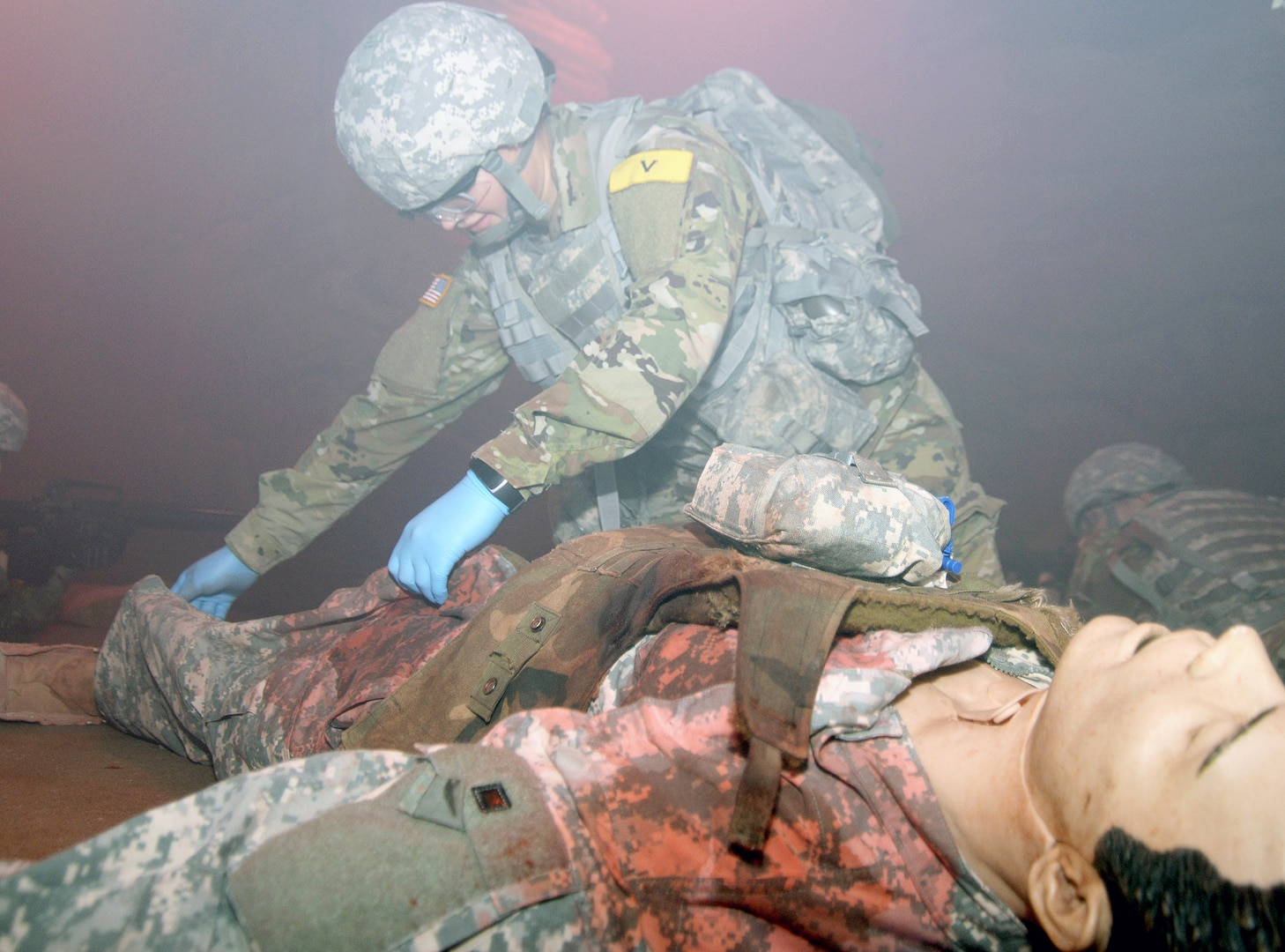 Pvt. Alyssa Swanson, 232nd Medical Battalion at Joint Base San Antonio-Fort Sam Houston, works on a  mannequin of a Soldier on a mockup set at the Combat Trauma Patient Simulation Lab, located at the Medical Education Training Campus at Joint Base San Antonio-Fort Sam Houston.