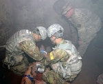 (From left) Pvt. Jason Wu and Pvt. Jeremiah Sanders work on a simulated patient under the instruction of Staff Sgt. Brian Worfman at the Combat Trauma Patient Simulation Lab, located at the Medical Education Training Campus at Joint Base San Antonio-Fort Sam Houston.