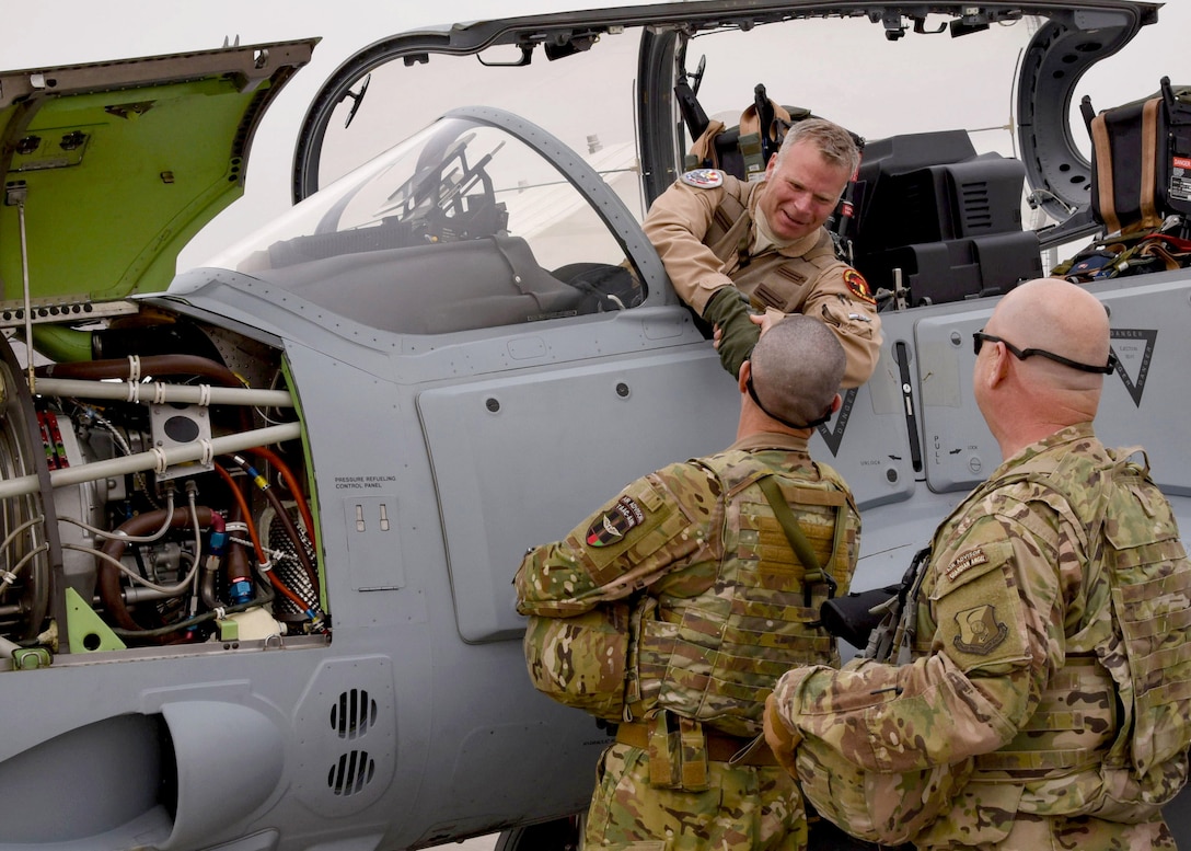 Train, Advise, Assist Command-Air (TAAC-Air) advisors welcome a U.S. pilot after transporting an A-29 Super Tucano light-attack aircraft arriving for duty at Kabul Air Wing, Kabul, Afghanistan, March 20, 2017. The A-29s will be used by the Afghan Air Force for close-air attack, air interdiction, escort and armed reconnaissance. These latest arrivals, which traveled from Moody Air Force Base, Ga., bring the AAF A-29 inventory from eight to 12 aircraft in country. (U.S. Air Force photo by Tech. Sgt. Veronica Pierce)