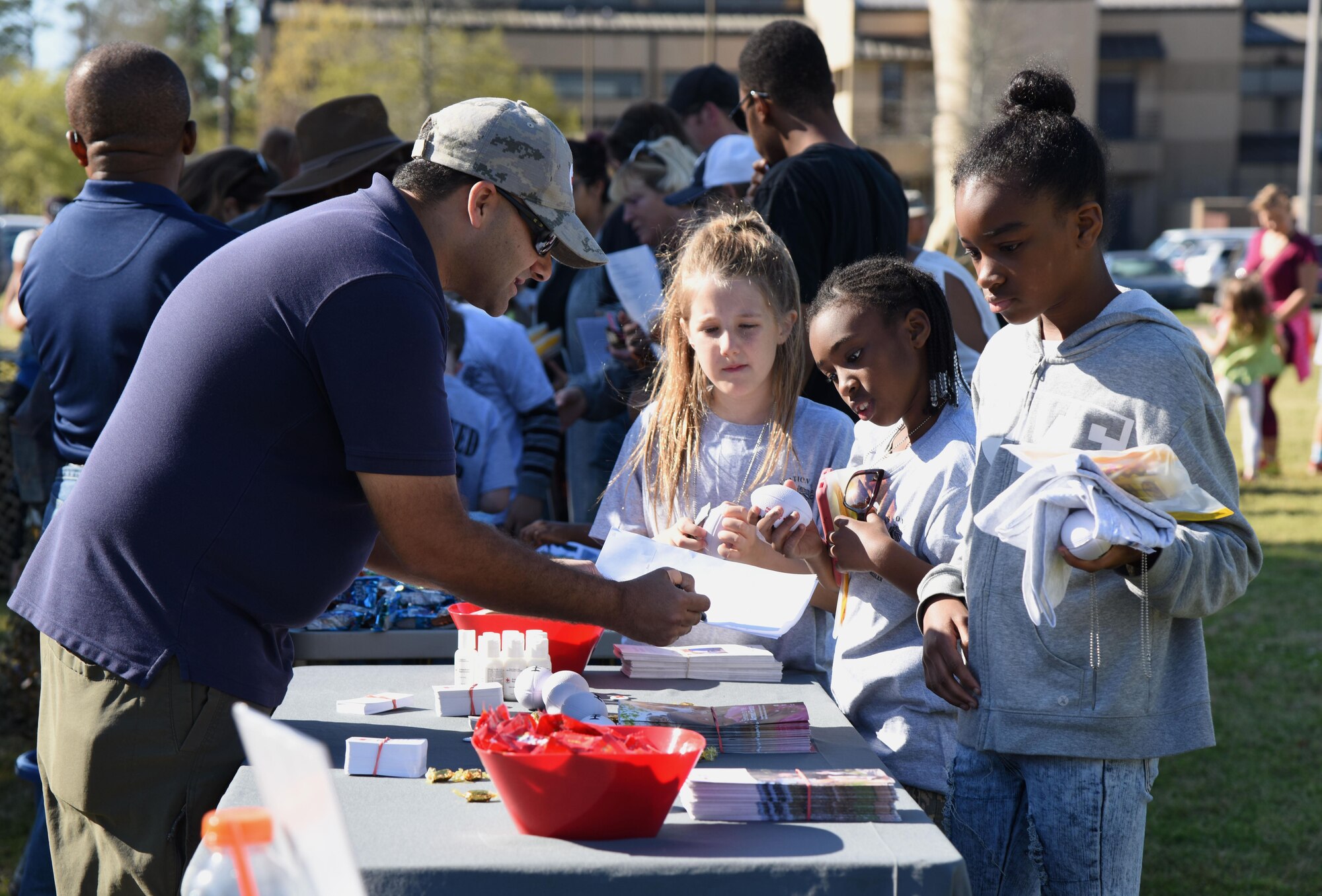 Keesler children process through a deployment line during Operation Hero March 18, 2017, on Keesler Air Force Base, Miss. The activities at the event were designed to help children better understand what their parents do when they deploy. (U.S. Air Force photo by Kemberly Groue)